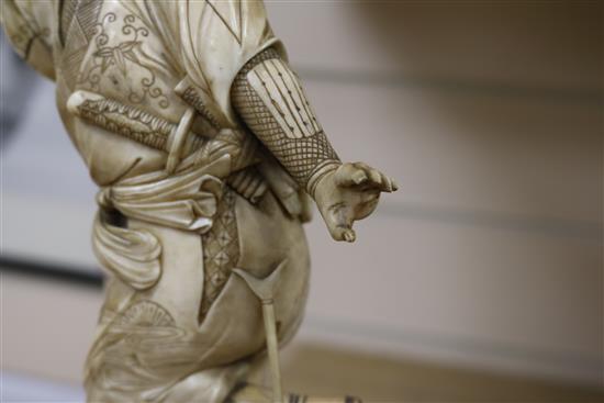 A Japanese ivory of a Samurai, Meiji period, 32.5cm, losses